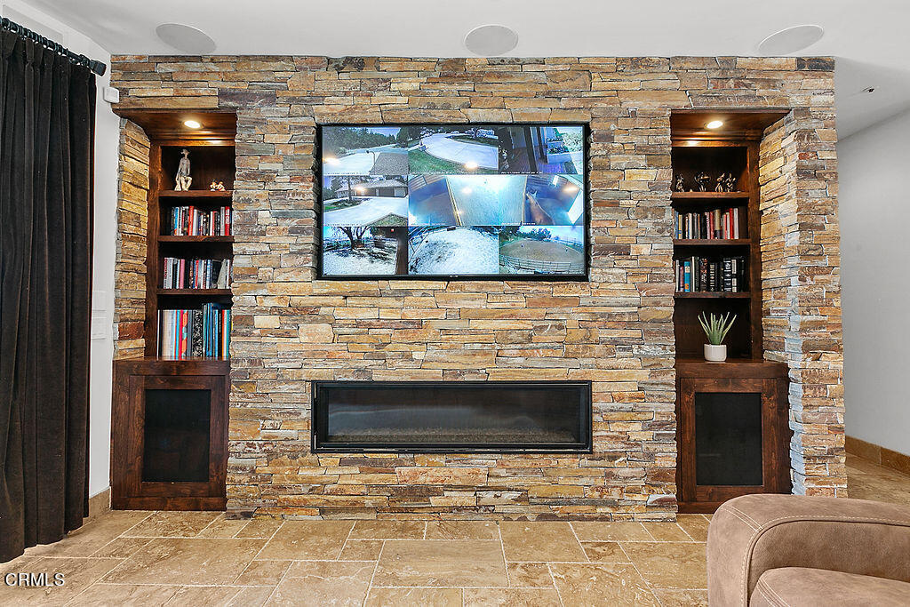 95 Avocado Place Camarillo, CA 93010 - Photo 19 of 74 a living room with a fireplace and a flat screen tv
