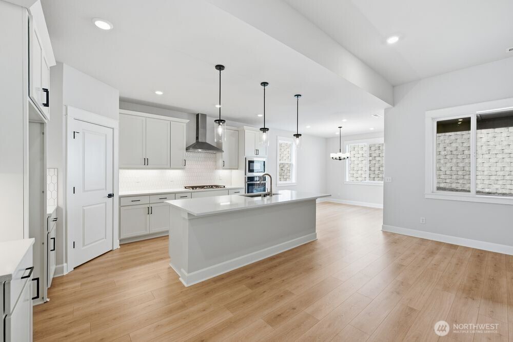2609 Acer Loop Southeast Lacey, WA 98513 - Photo 3 of 28 a large kitchen with kitchen island a sink stainless steel appliances and cabinets