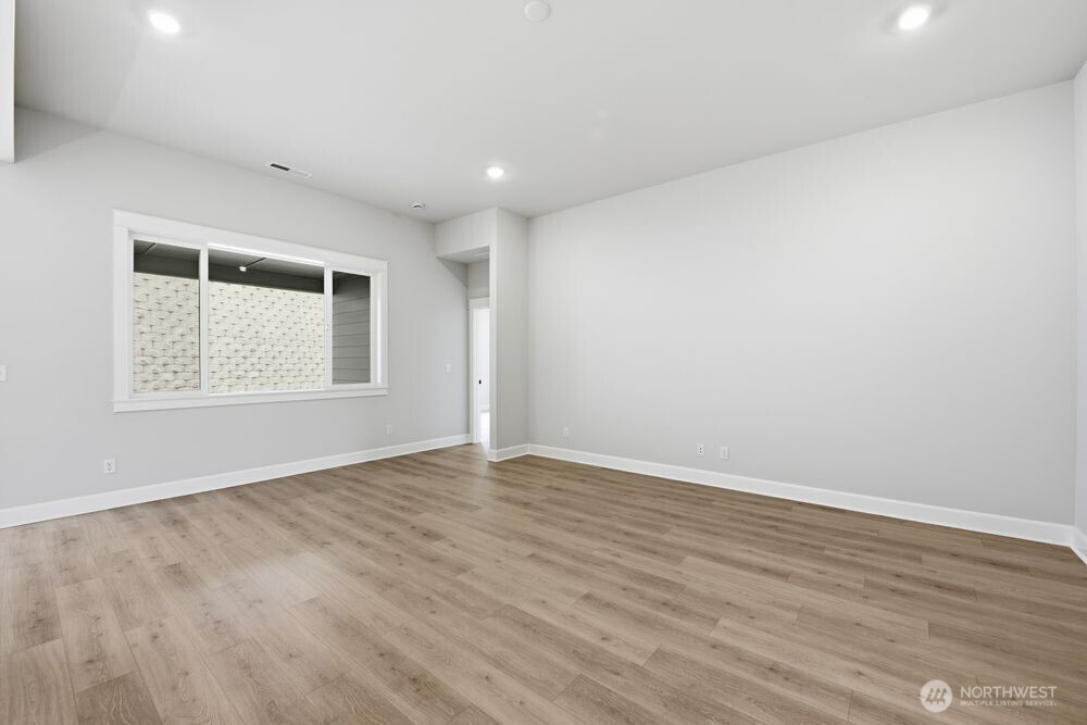 2609 Acer Loop Southeast Lacey, WA 98513 - Photo 5 of 28 an empty room with wooden floor and windows