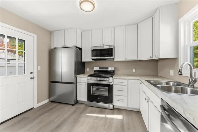 a kitchen with a sink stove and refrigerator