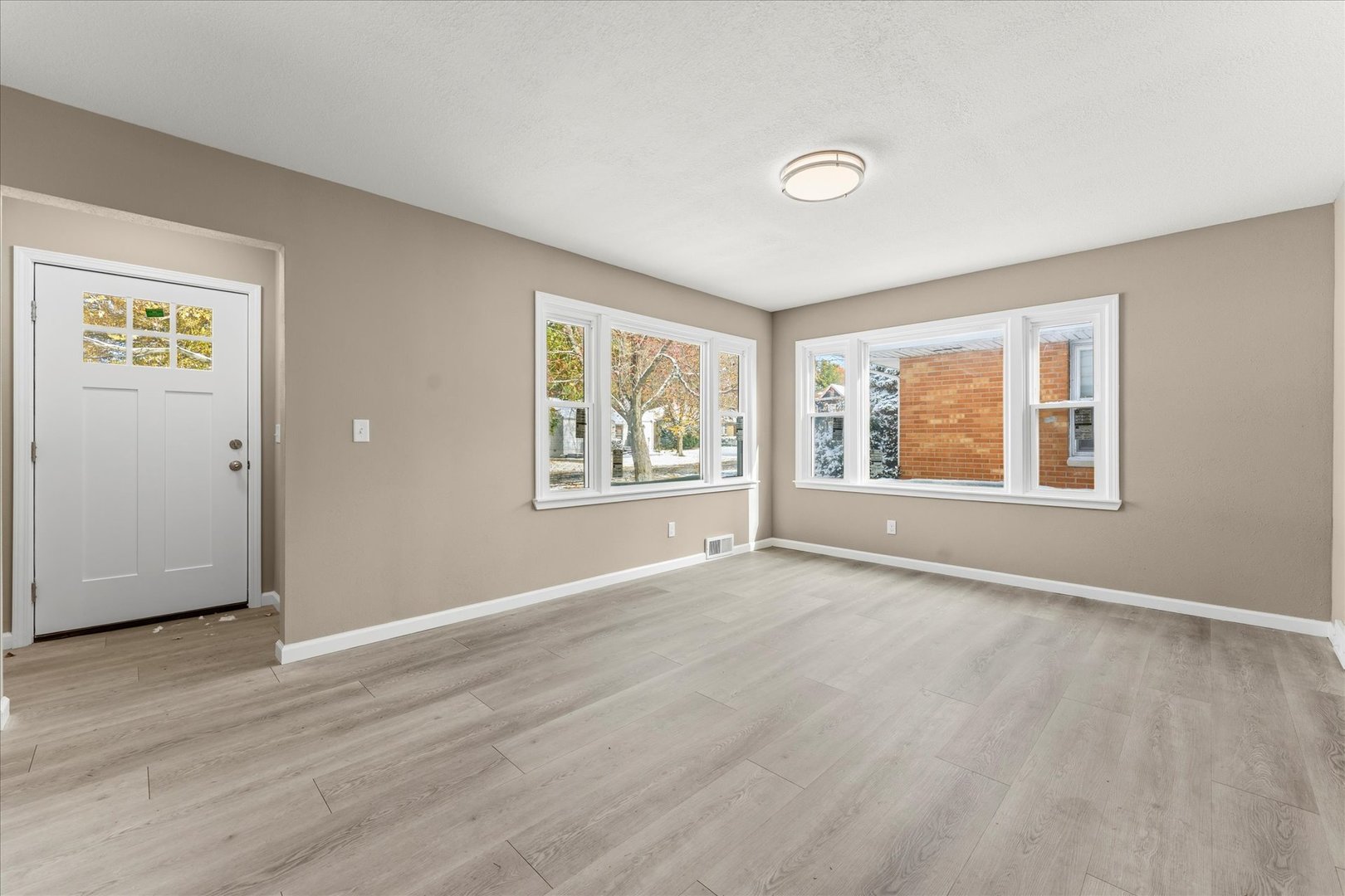 1407 West Clark Street Champaign, IL 61821 - Photo 7 of 28 an empty room with wooden floor and windows