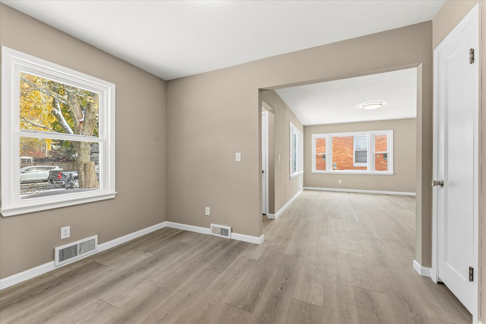 1407 West Clark Street Champaign, IL 61821 - Photo 9 of 28 a view of an empty room with wooden floor and a window
