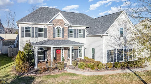 a front view of house with yard outdoor seating and barbeque oven