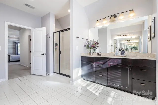 a bathroom with a sink vanity and a mirror