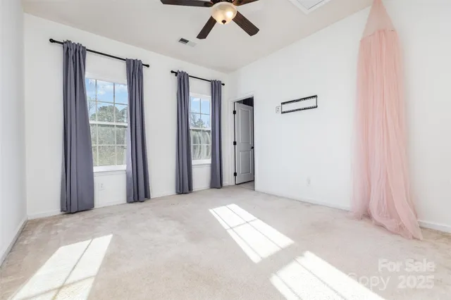 a view of a livingroom with a ceiling fan and window