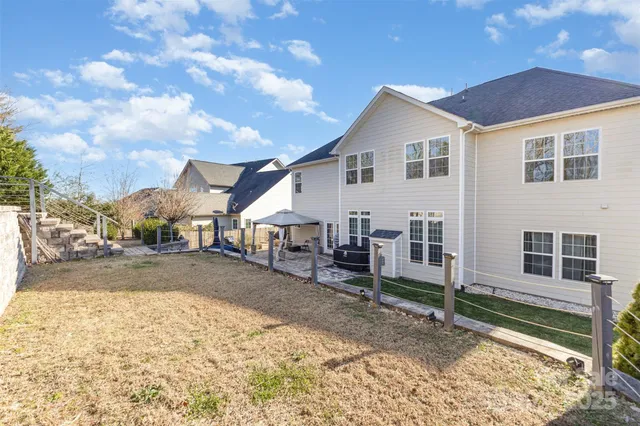 a view of a house with wooden fence