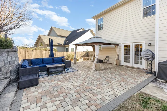 a view of a porch with furniture and a yard