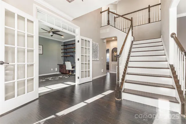 a view of entryway with wooden floor and windows