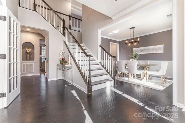 a view of entryway and hall with wooden floor