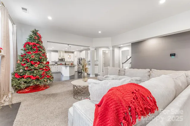 a living room with furniture and flowers