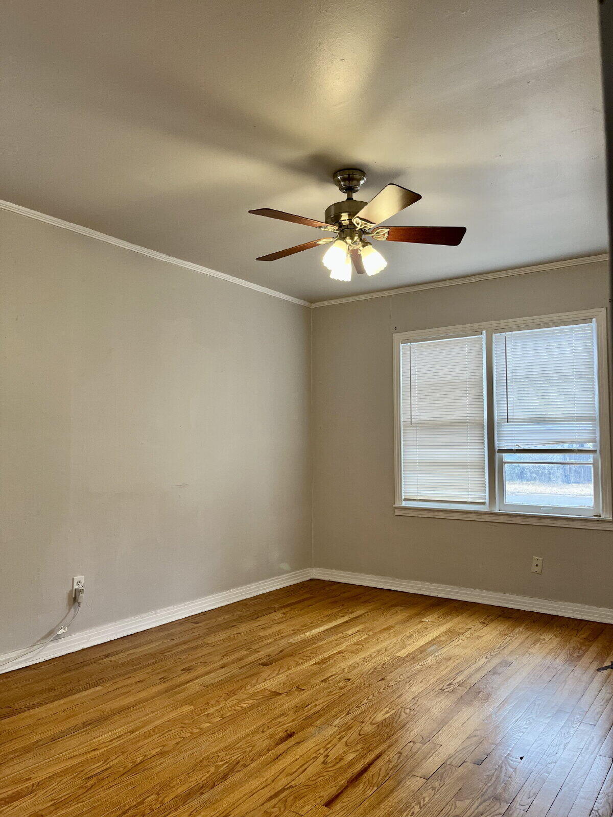 3414 24th Street, Unit FRONT Lubbock, TX 79410 - Photo 11 of 21 an empty room with a window and a fan