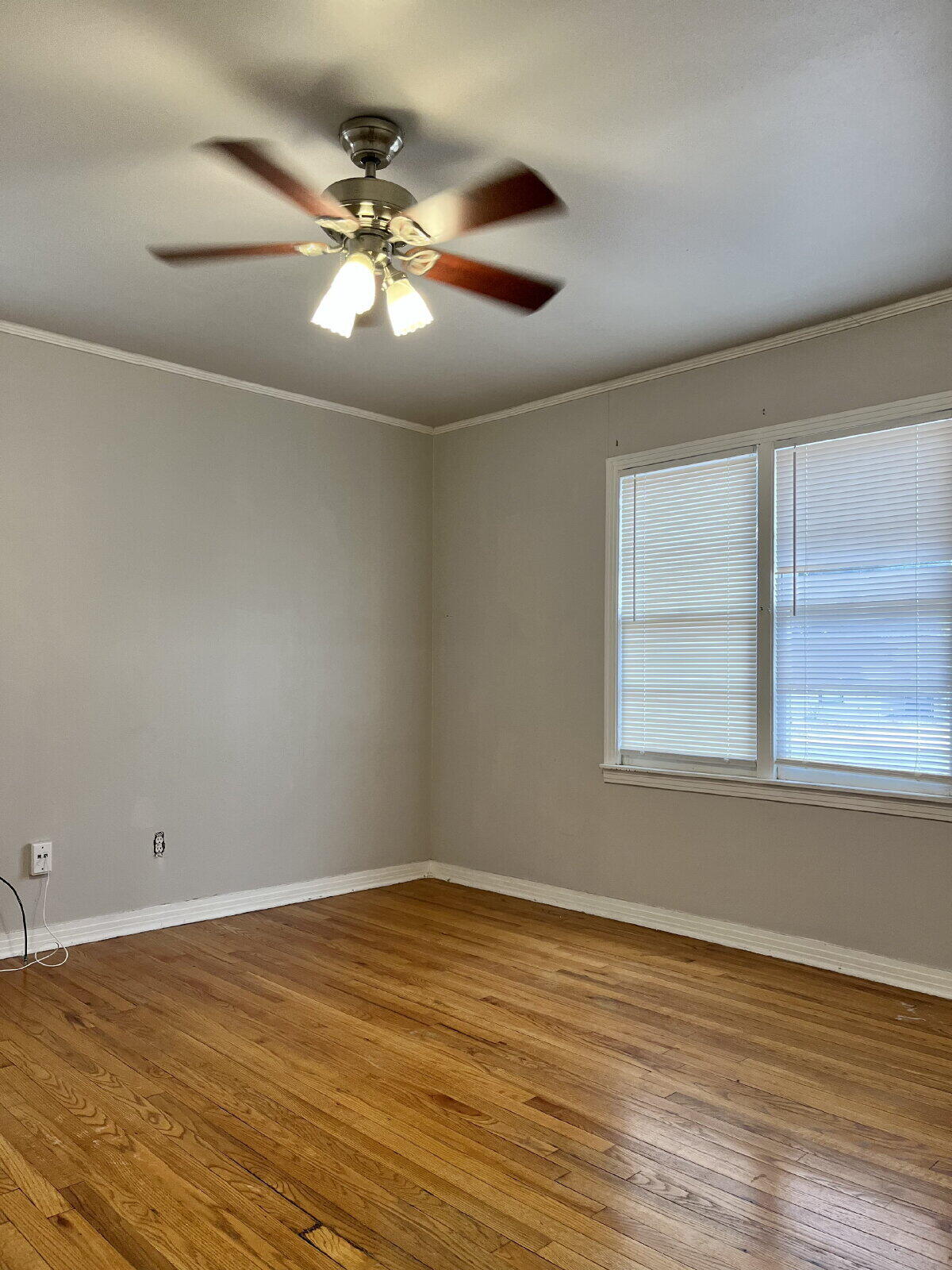 3414 24th Street, Unit FRONT Lubbock, TX 79410 - Photo 17 of 21 an empty room with wooden floor and windows
