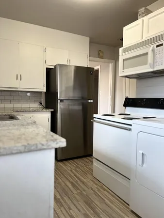 a kitchen with a refrigerator and a sink