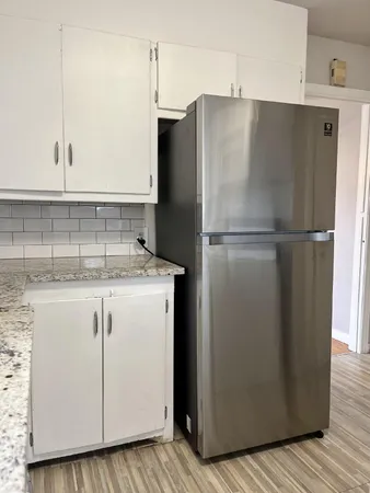 a white refrigerator freezer sitting inside of a kitchen