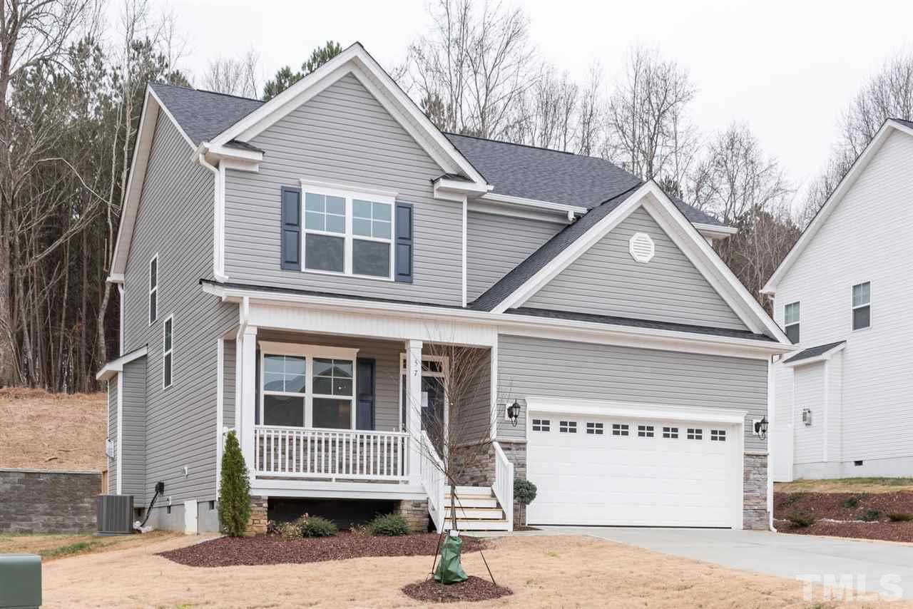 57 Ravencliff Ridge Garner, NC 27529 - Photo 2 of 25 a front view of a house with a yard and garage