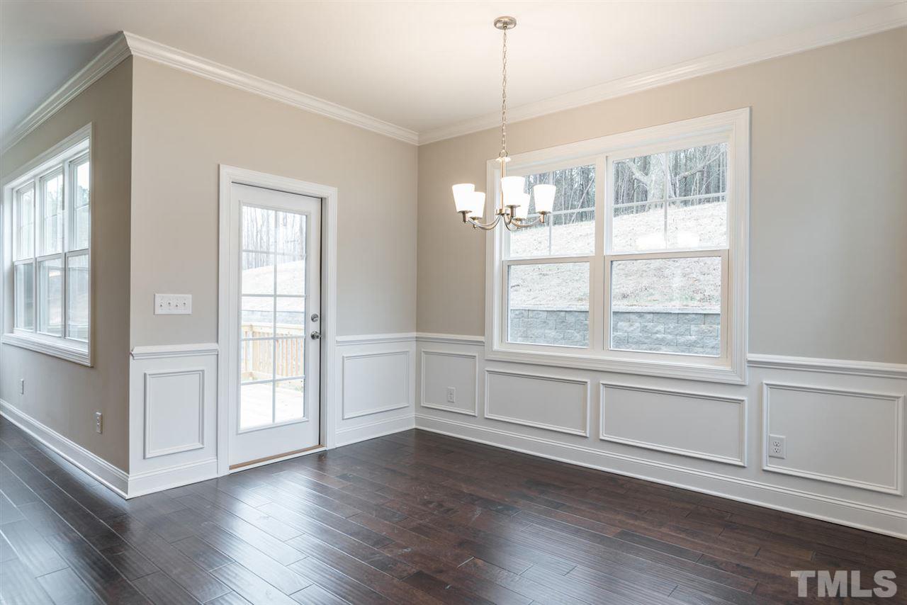 57 Ravencliff Ridge Garner, NC 27529 - Photo 14 of 25 a view of an empty room with wooden floor and a window
