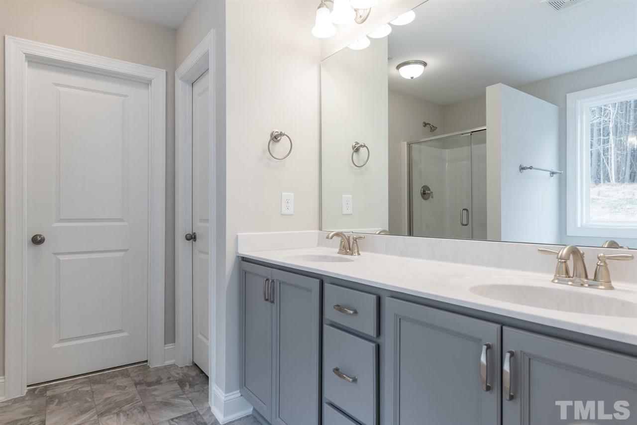57 Ravencliff Ridge Garner, NC 27529 - Photo 17 of 25 a bathroom with a sink double vanity and a mirror