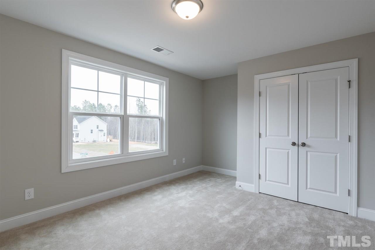 57 Ravencliff Ridge Garner, NC 27529 - Photo 19 of 25 a view of an empty room with a window and closet area