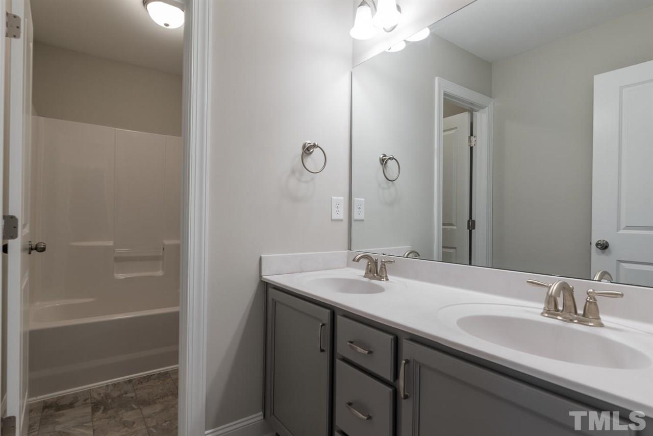 57 Ravencliff Ridge Garner, NC 27529 - Photo 20 of 25 a bathroom with a sink and a mirror