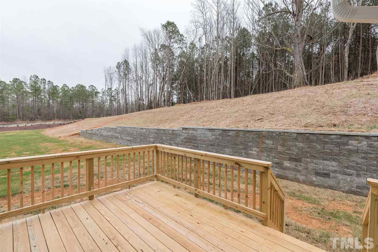 57 Ravencliff Ridge Garner, NC 27529 - Photo 22 of 25 a view of roof deck with large trees and wooden fence