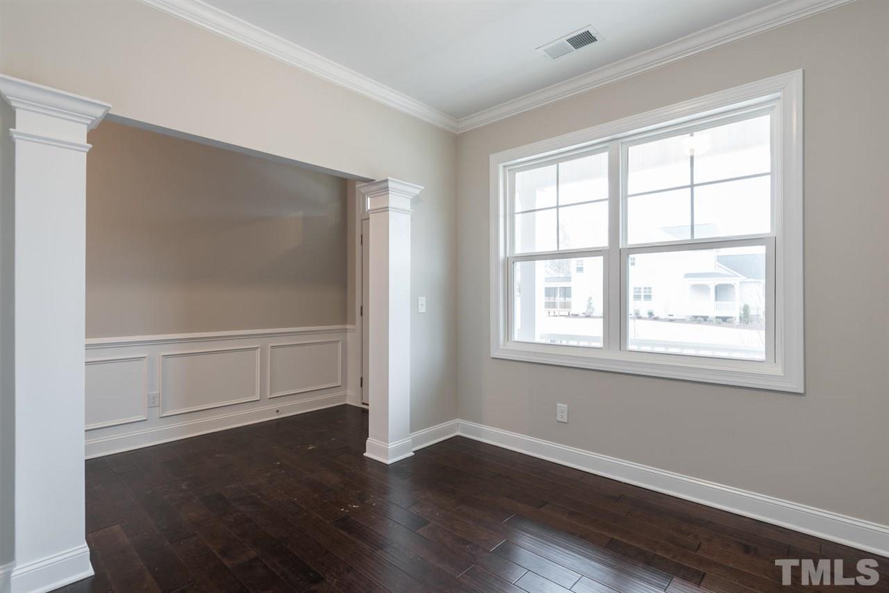 57 Ravencliff Ridge Garner, NC 27529 - Photo 4 of 25 a view of an empty room with wooden floor and a window