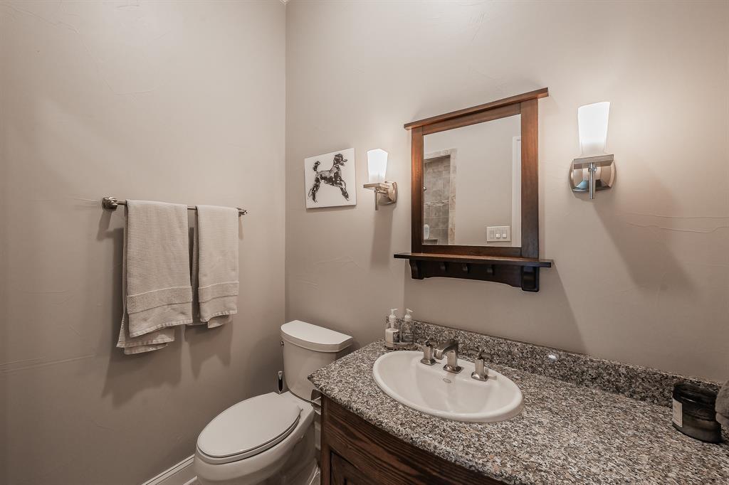 115 Pheasant Run Road Argyle, TX 76226 - Photo 32 of 40 a bathroom with a granite countertop sink toilet and a mirror