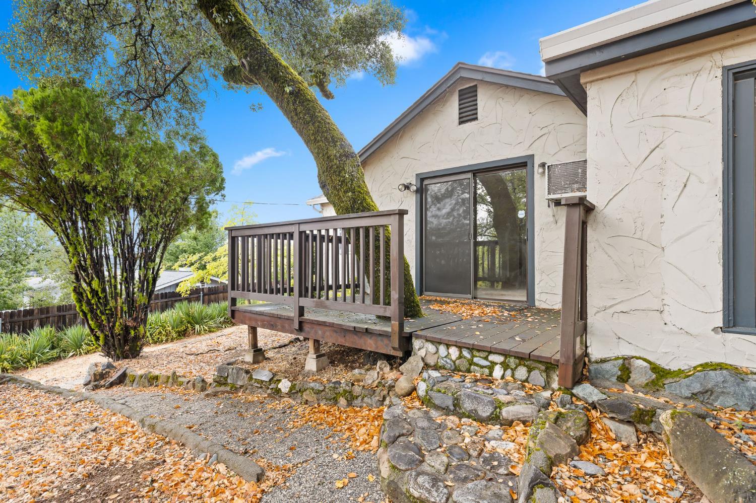 225 Flood Road Auburn, CA 95603 - Photo 28 of 30 a view of a small house with backyard and wooden fence