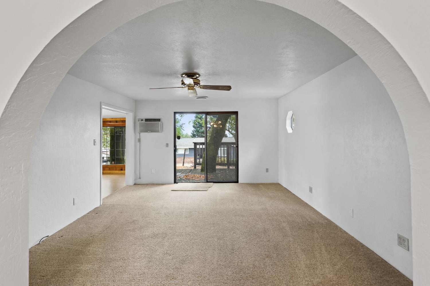225 Flood Road Auburn, CA 95603 - Photo 8 of 30 an empty room with chandelier fan and windows
