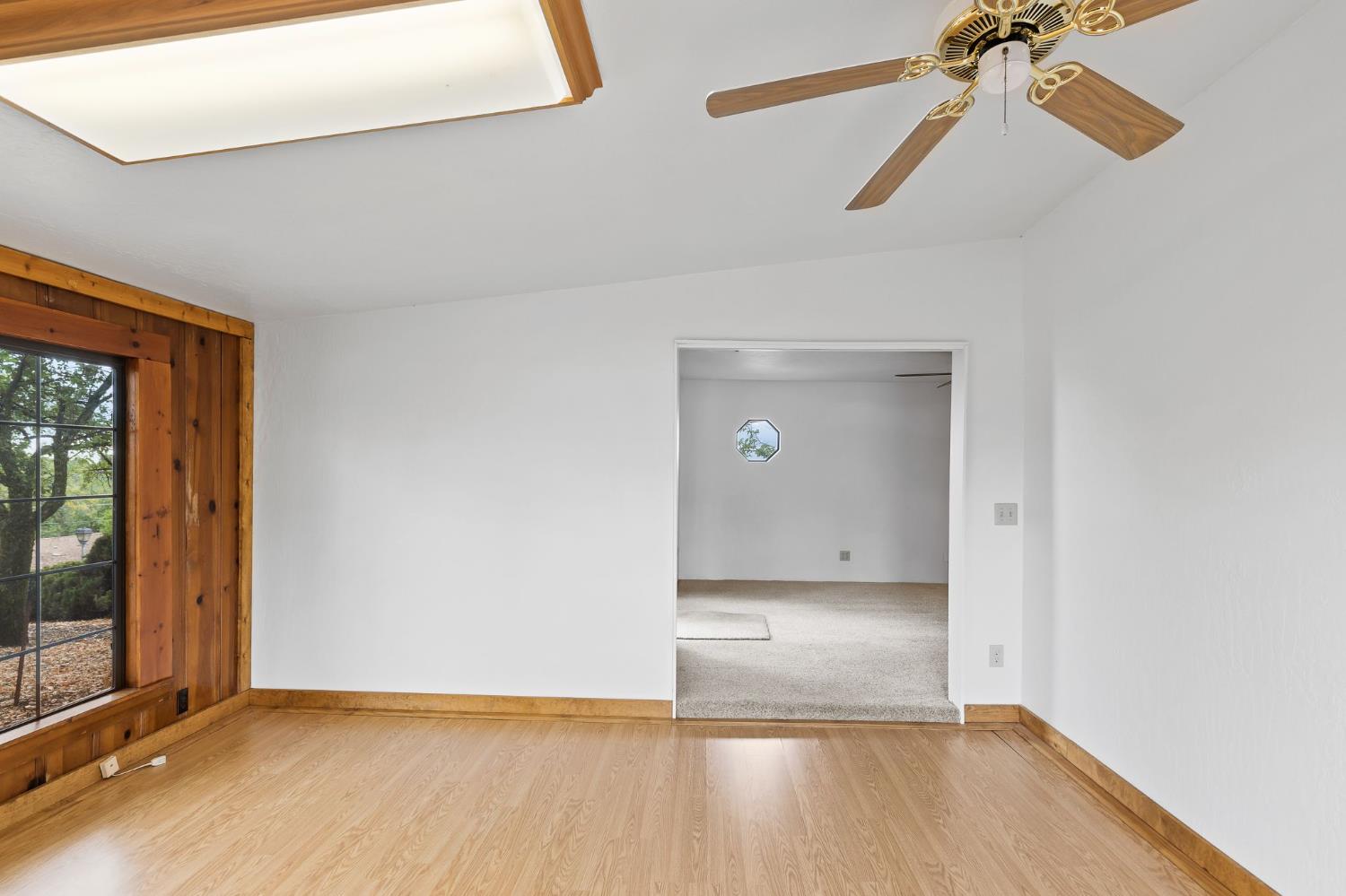 225 Flood Road Auburn, CA 95603 - Photo 10 of 30 a view of a room with wooden floor and a ceiling fan