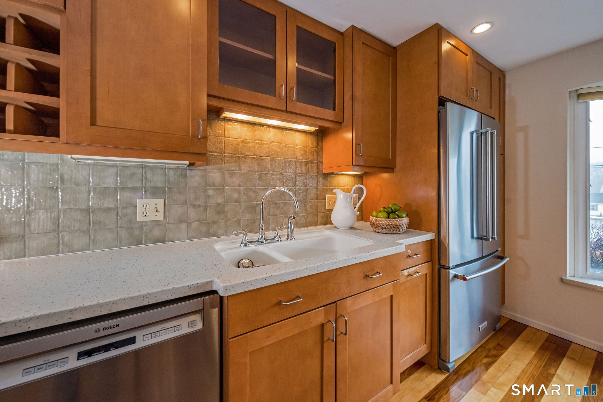 a kitchen with stainless steel appliances granite countertop a refrigerator and a sink