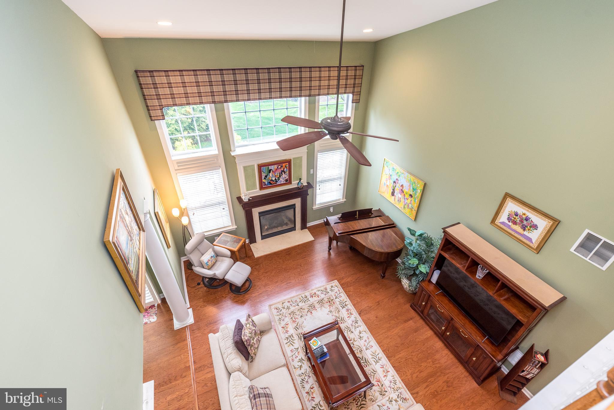 131 Mahogany Way Upper Gwynedd, PA 19446 - Photo 33 of 52 a living room with furniture a rug and a floor to ceiling window