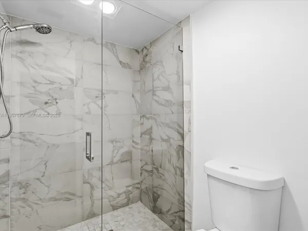 a bathroom with a shower and a toilet