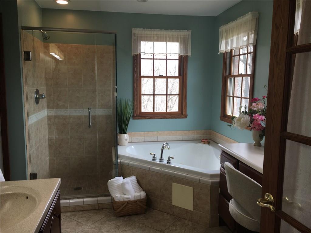 643 Neville Road Beaver, PA 15009 - Photo 10 of 25 The master bath with a walk in shower and a small dressing table. The walk in closet is to the left