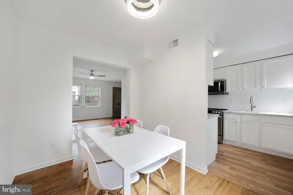 a view of a dining room with furniture and wooden floor