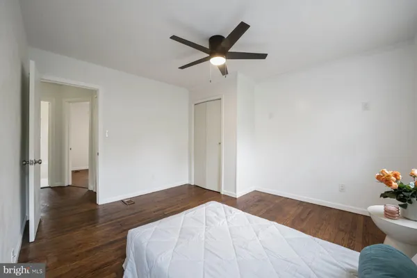 a bedroom with a bed and a ceiling fan