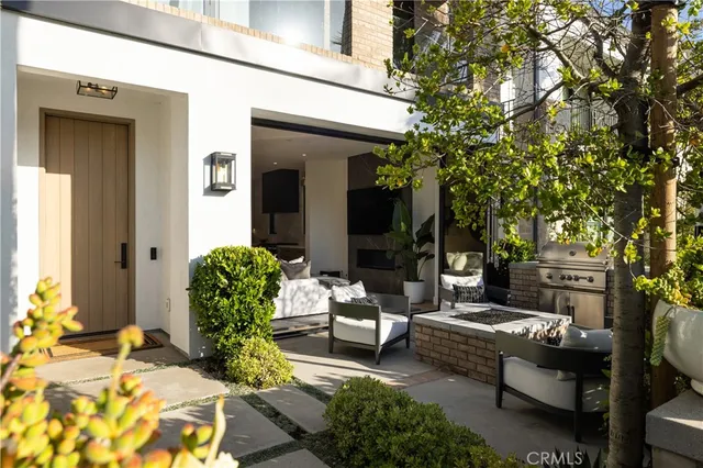 a view of a patio with couches table and chairs and potted plants