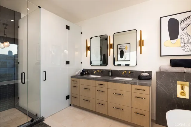 a bathroom with a granite countertop sink a toilet a mirror and shower