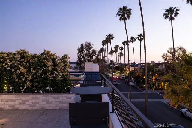 a view of a balcony with a table chairs and a potted plant