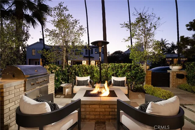 a view of a house with backyard and sitting area