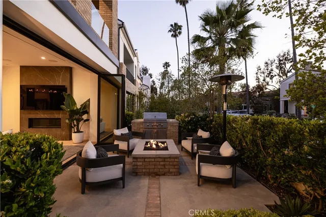 a view of a patio with couches table and chairs and potted plants