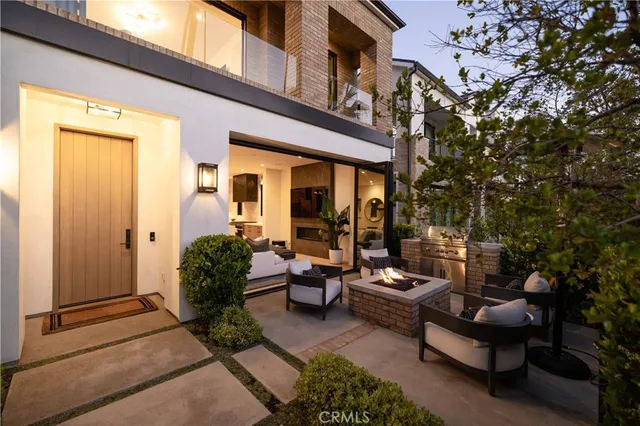a view of a patio with couches table and chairs and potted plants