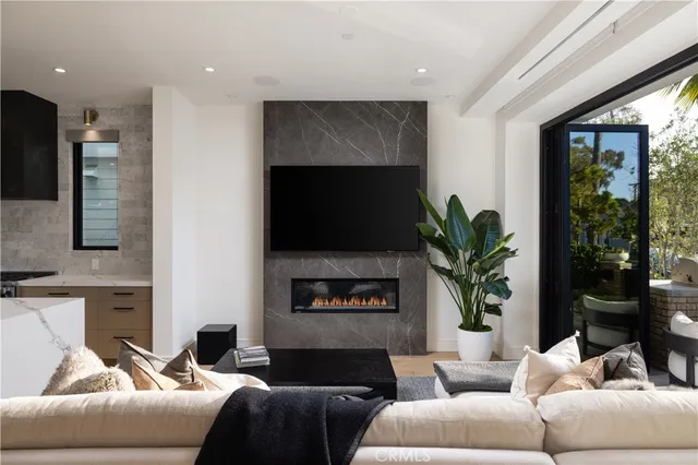 a living room with furniture a fireplace and a flat screen tv