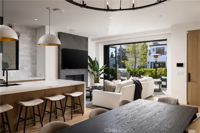 a living room with furniture a large window and a flat screen tv