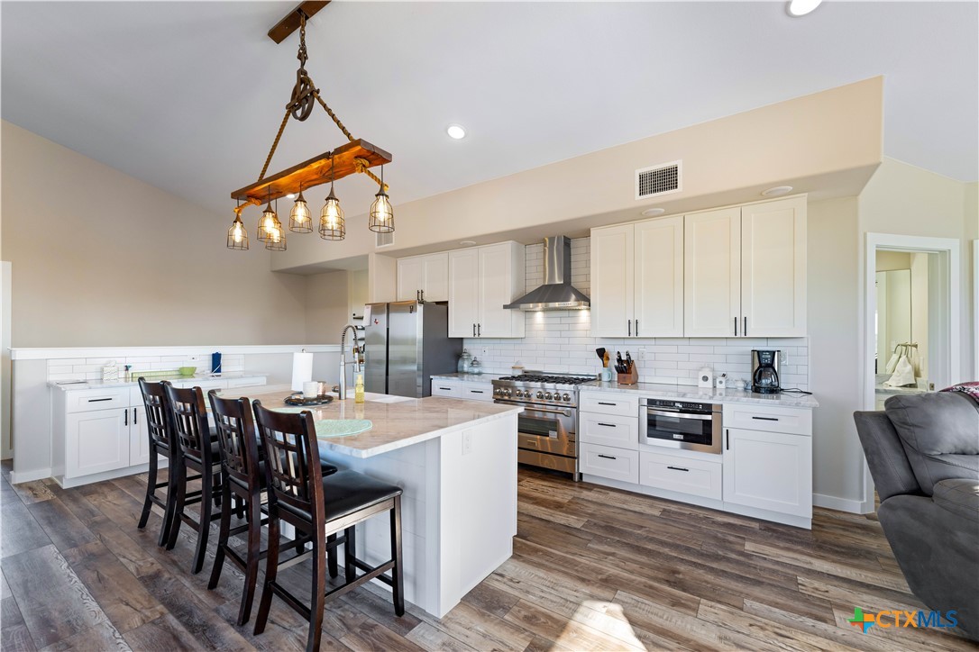 582 Delaware Creek Road Boerne, TX 78006 - Photo 17 of 48 a view of a dining room with furniture window and wooden floor