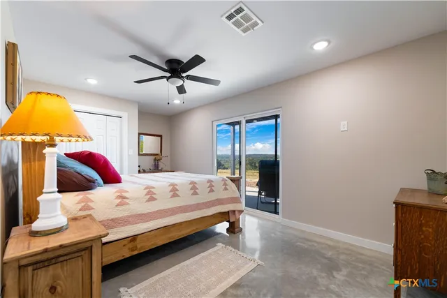 a bathroom with a granite countertop sink a toilet and a mirror