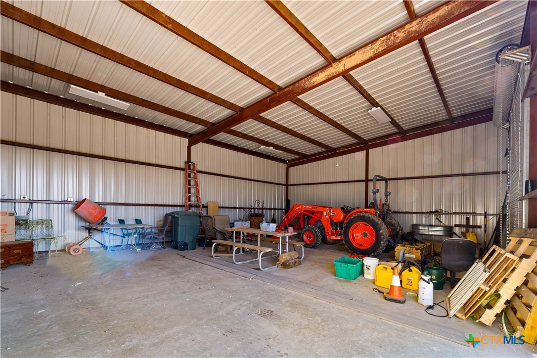582 Delaware Creek Road Boerne, TX 78006 - Photo 34 of 48 a view of a garage with a table and chairs