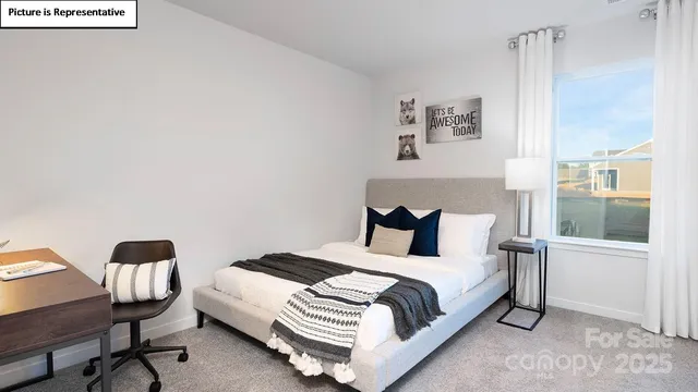 a bed room with a bed and a chair