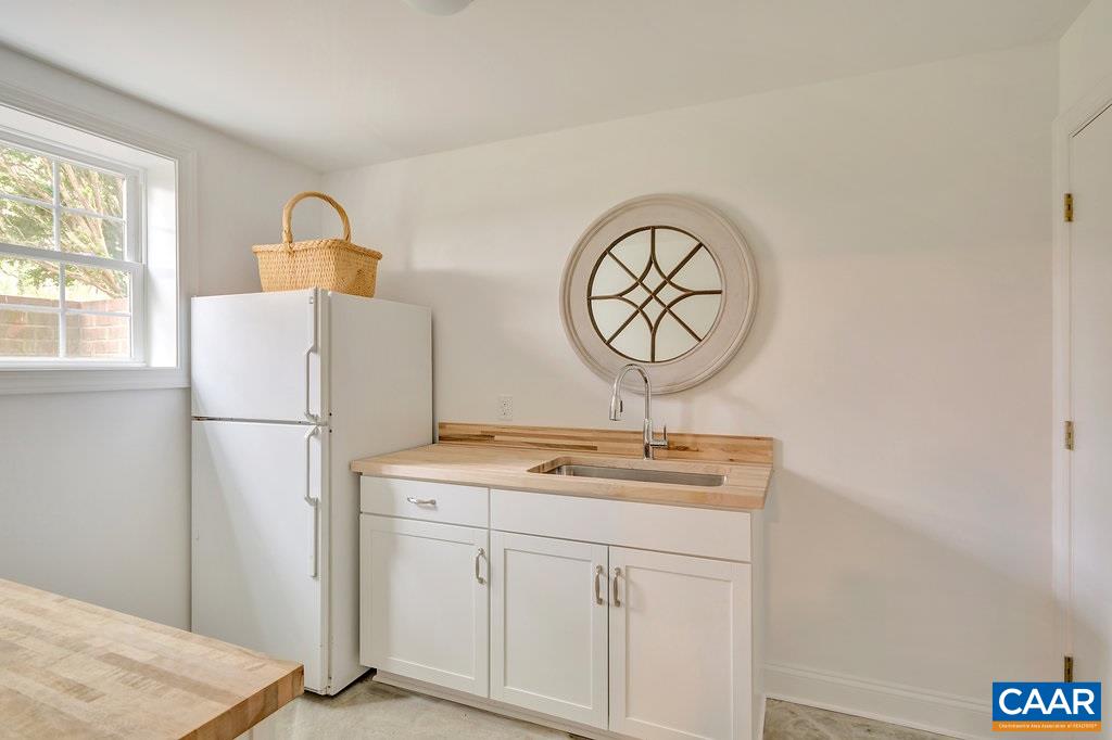 1893 Westview Road Charlottesville, VA 22903 - Photo 31 of 35 a room with a sink a mirror and a window