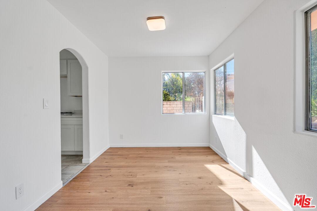 25845 Browning Place Stevenson Ranch, CA 91381 - Photo 14 of 36 an empty room with wooden floor and windows