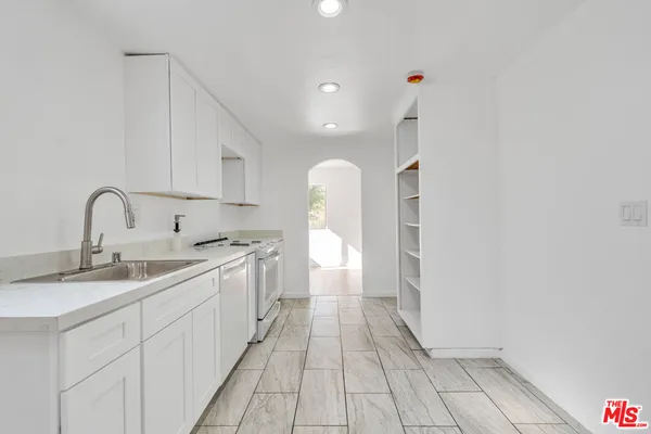 a kitchen with a sink and cabinets